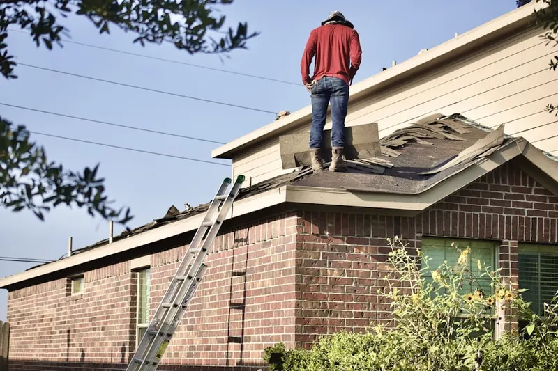 Professional roofer working on a residential roof in Piety Corner